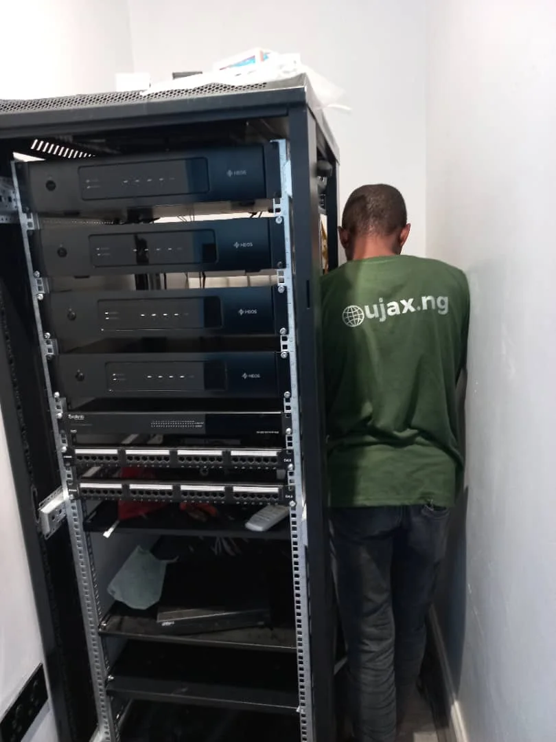 Ujax technician working on an integrated AV equipment rack